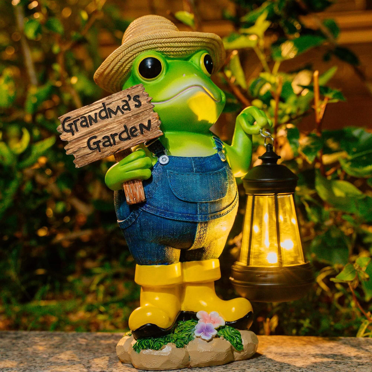 Qmaggice frog garden statue with solar light glowing at dusk to welcome guests