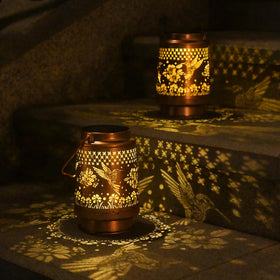 QPPDER solar lantern garden decor glows warmly, perfect for patios and pathways.