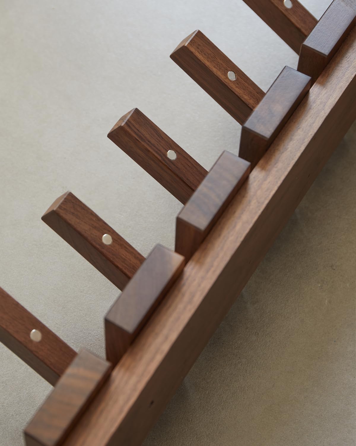 QUELLANCE wood coat rack mounted beside the door for tidy entryways