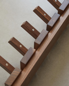 QUELLANCE wood coat rack mounted beside the door for tidy entryways