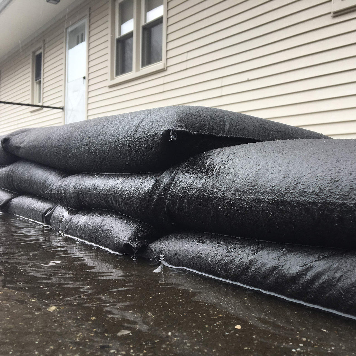 Water-activated barrier protects garages, doorways, and low-lying areas.