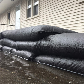 Water-activated barrier protects garages, doorways, and low-lying areas.