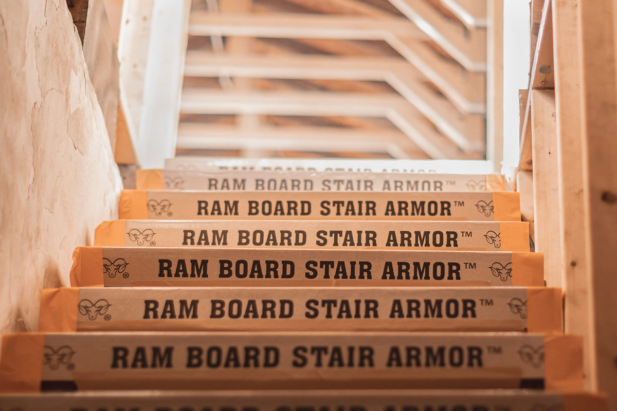 Ram Board Stair Armor shows Spill Guard technology to contain liquids on site.