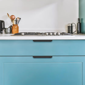 Ravinte black finger pulls installed on modern furniture detail