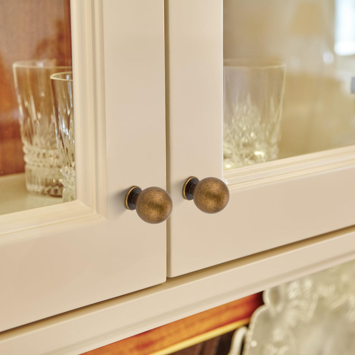 Round ball knob on a drawer front with smooth edges and refined silhouette.