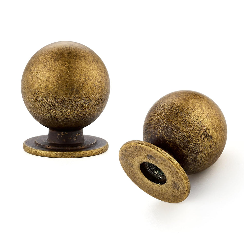 Ravinte Decor round knob in antique brass on a cabinet adds warm, timeless appeal