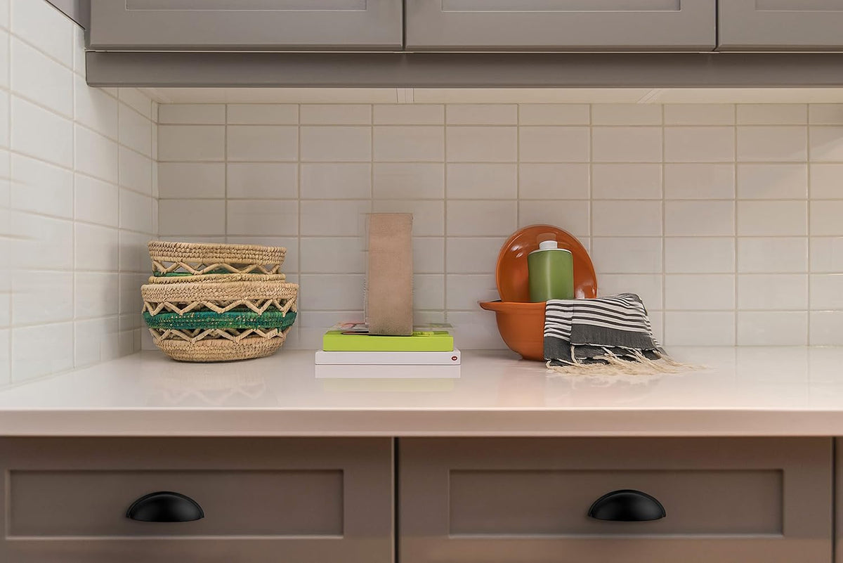 Ravinte half-moon cup pulls offer contemporary flair on drawers.