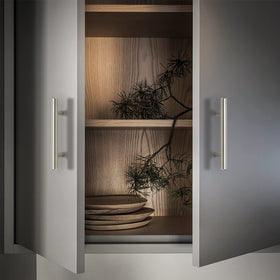 Ravinte satin nickel hardware complements appliances for a cohesive look.