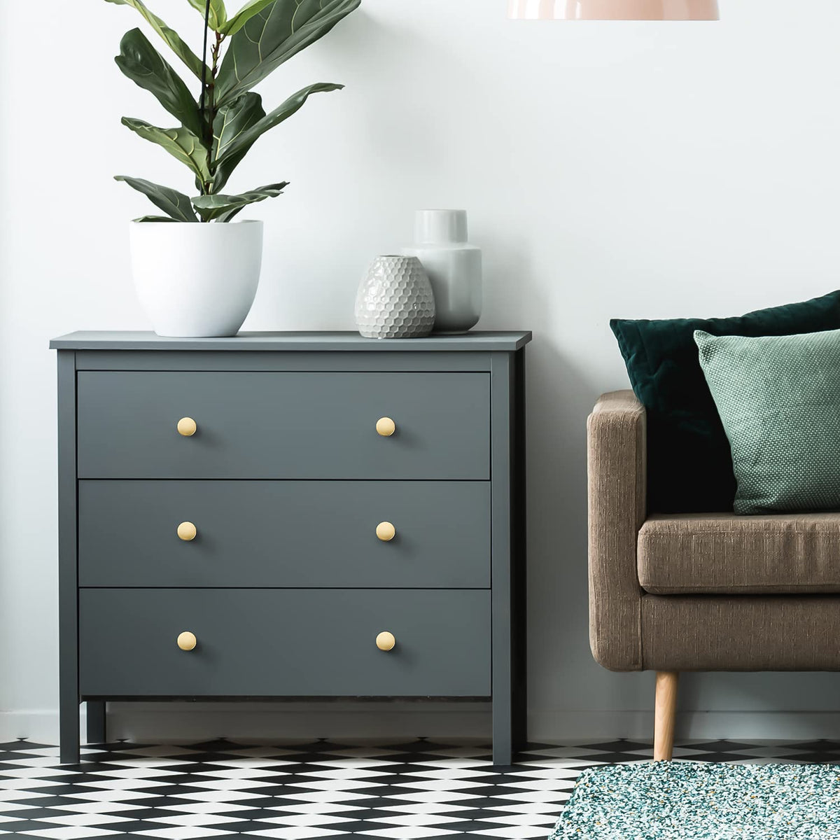 Ravinte dresser hardware in brushed brass on a wooden surface demonstrates durability