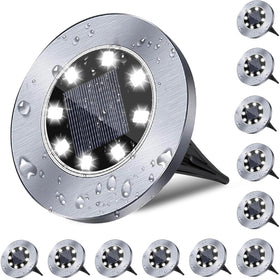 Rayolon solar ground light 8-LED disk brightening a dark walkway