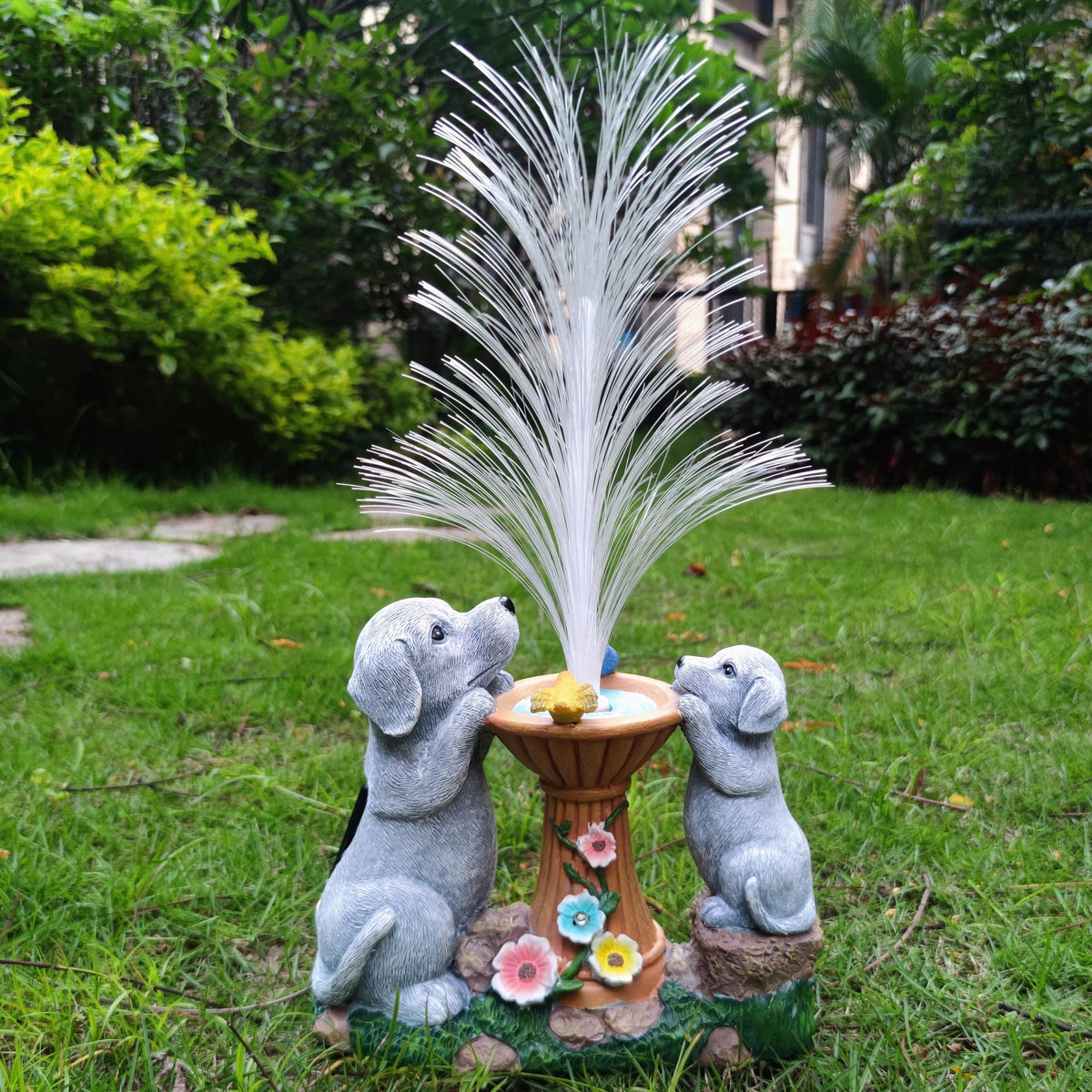 Resin dog figurines feature two dogs admiring a luminous fountain centerpiece