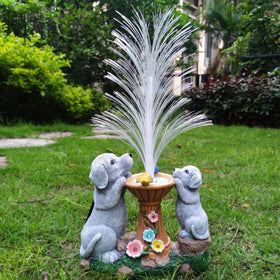 Resin dog figurines feature two dogs admiring a luminous fountain centerpiece