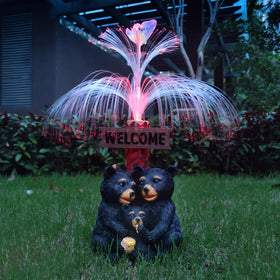 RCTTICUU solar bear statue with welcome card glows warmly at night.