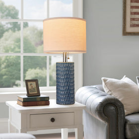 Reaketon bedside lamps on nightstand create warm, inviting mood.