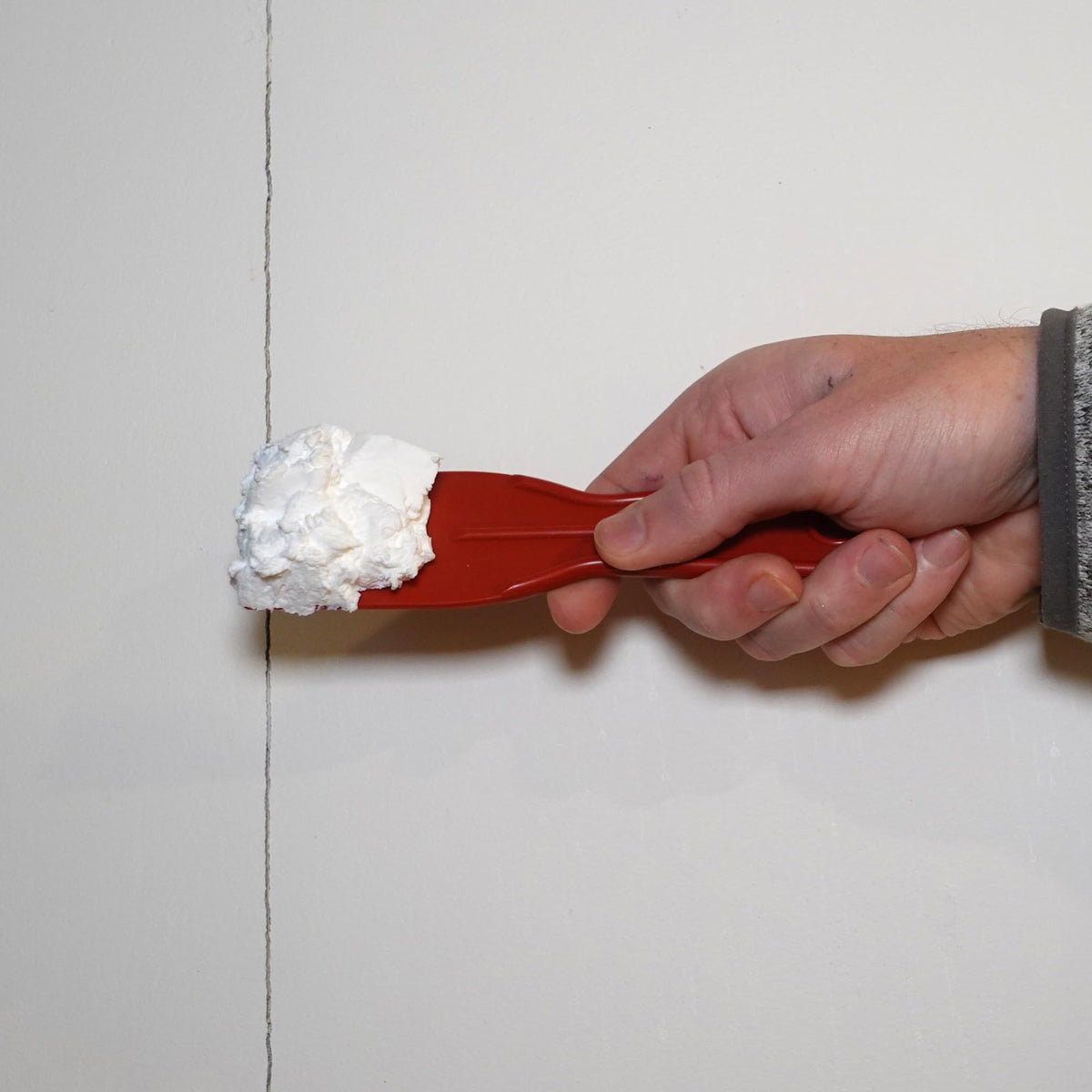 Red Devil ONETIME fills a hole in drywall without shrinking or sagging.