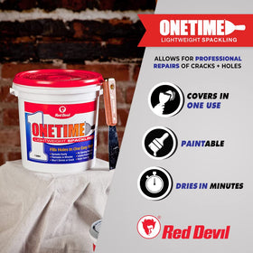 Red Devil ONETIME spackle being smoothed on drywall for seamless repairs.