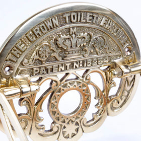 Renovators brass toilet paper holder supports space-saving bathroom organization.