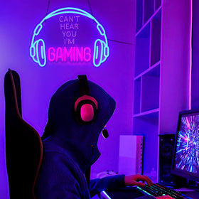 ReyeeInc neon sign on desk setup adds vibrant color to play area.