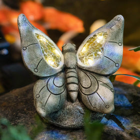 Rezpuao butterfly statue, front view, adds garden charm at night.