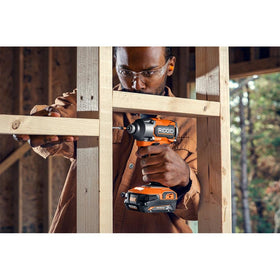 RIDGID 18V brushless impact driver in workspace shows portability and efficiency.