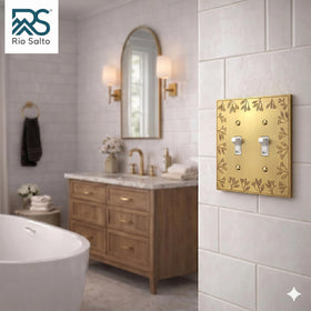 Brushed brass two-gang wall plate enhances switches with premium metal durability.