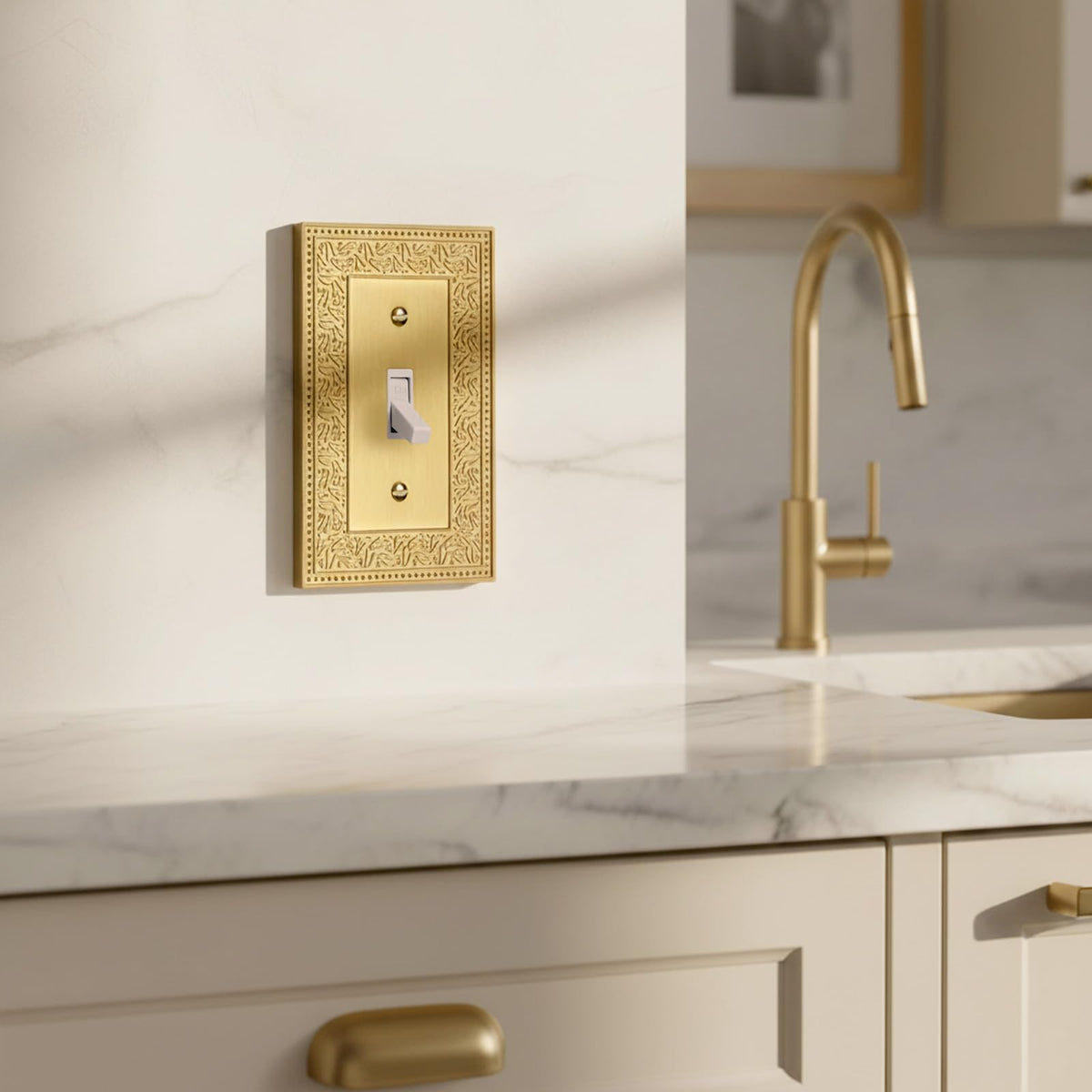 Close-up of Laurel brushed brass toggle showing intricate engraving