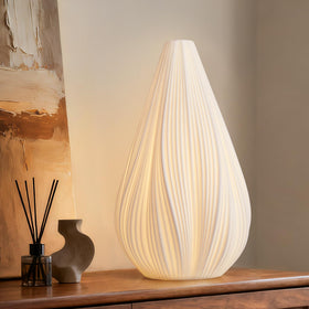 RONDURE 12.5-inch modern ceramic table lamp with shade emits warm translucent glow.