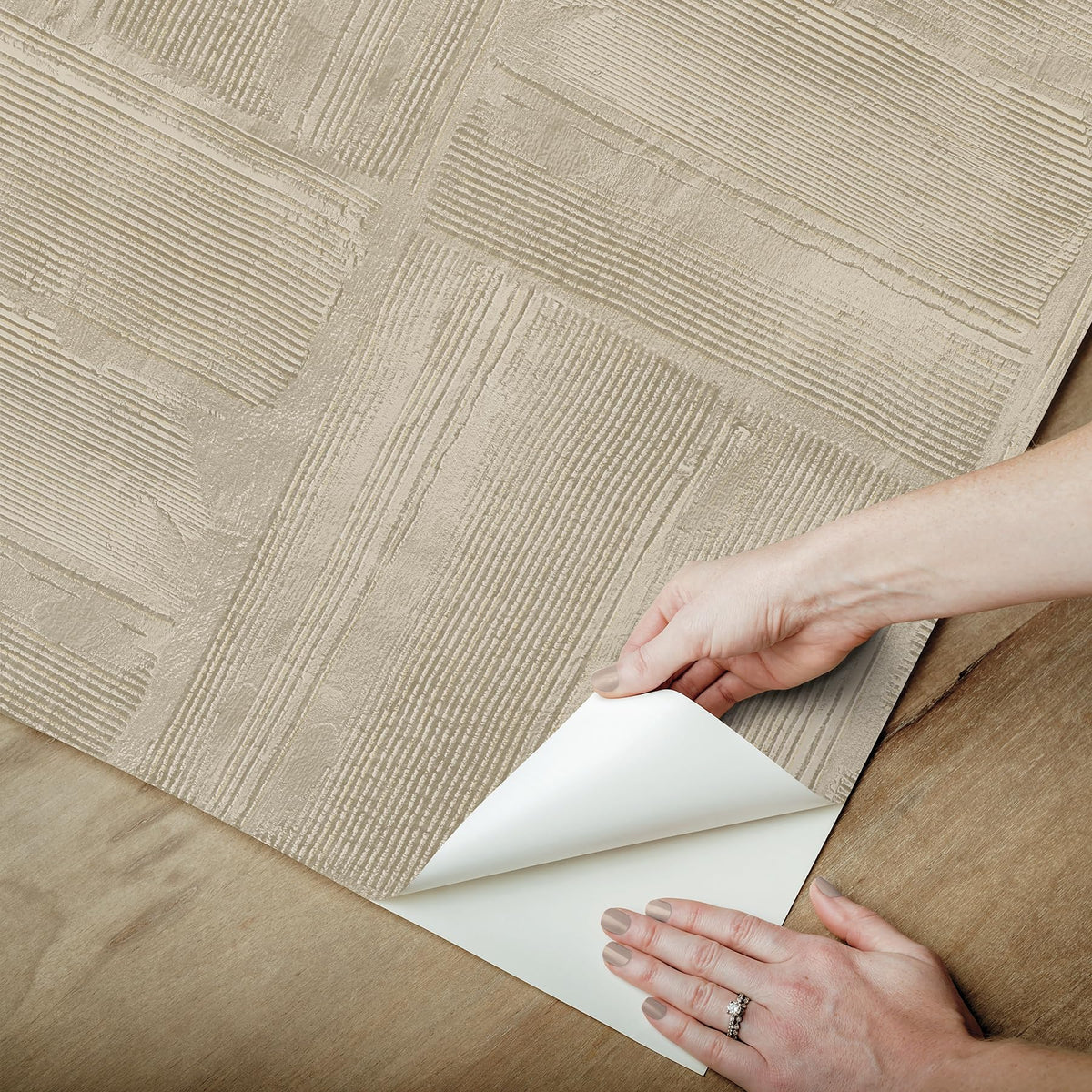 RoomMates taupe plaster texture close-up emphasizes plaster-like finish.