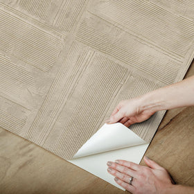 RoomMates taupe plaster texture close-up emphasizes plaster-like finish.