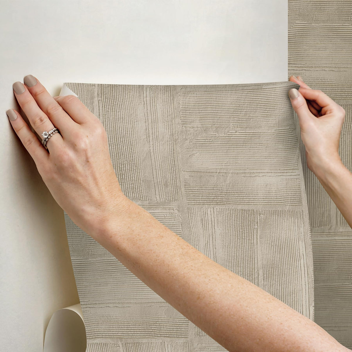 RoomMates taupe wallpaper in a room setting shows versatile styling options.