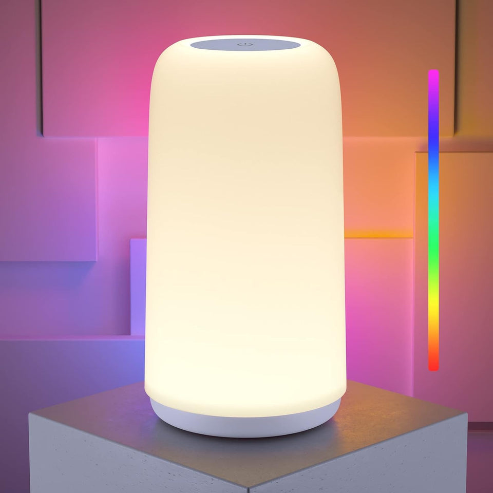 ROOTRO Touch bedside lamp emits a soft ambient glow on a nightstand.