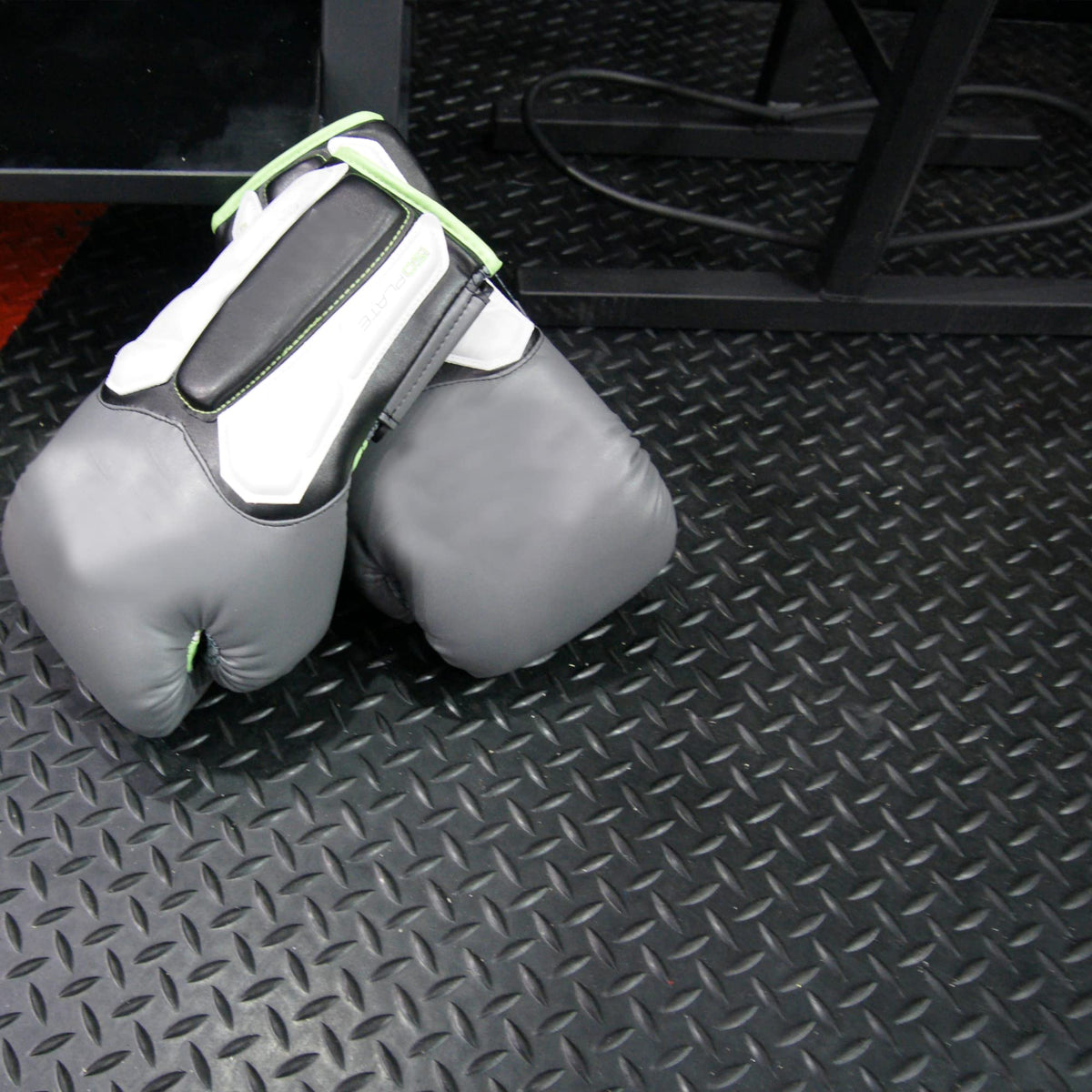 Diamond-Plate garage floor covering by Rubber-Cal reduces wear and damage.