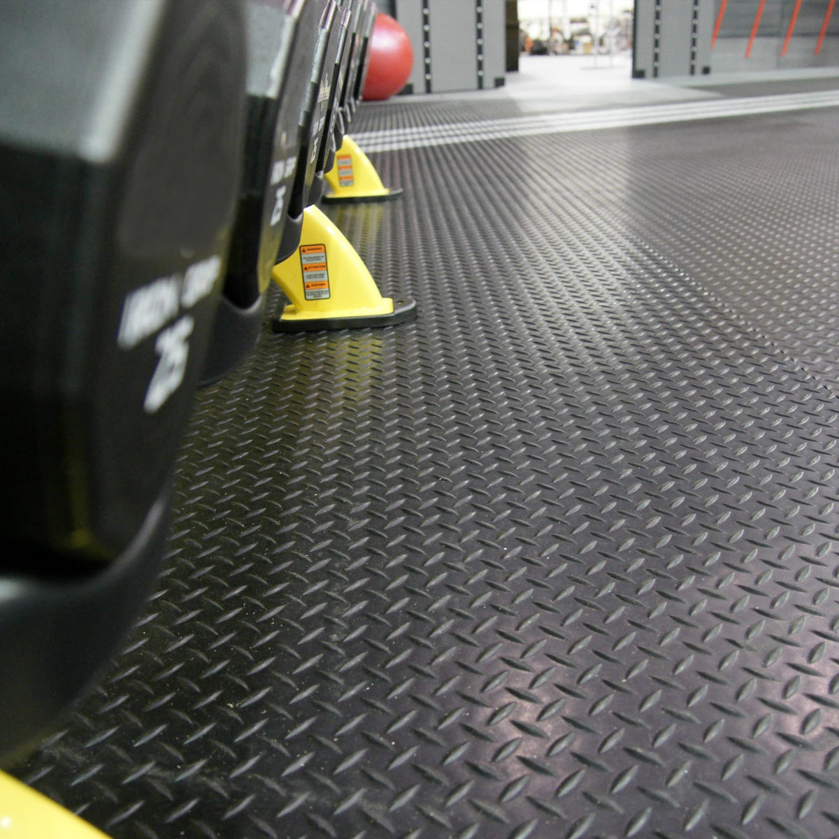 Rubber-Cal Diamond-Plate van floor mat protecting vehicle interior and gear.