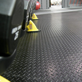 Rubber-Cal Diamond-Plate van floor mat protecting vehicle interior and gear.