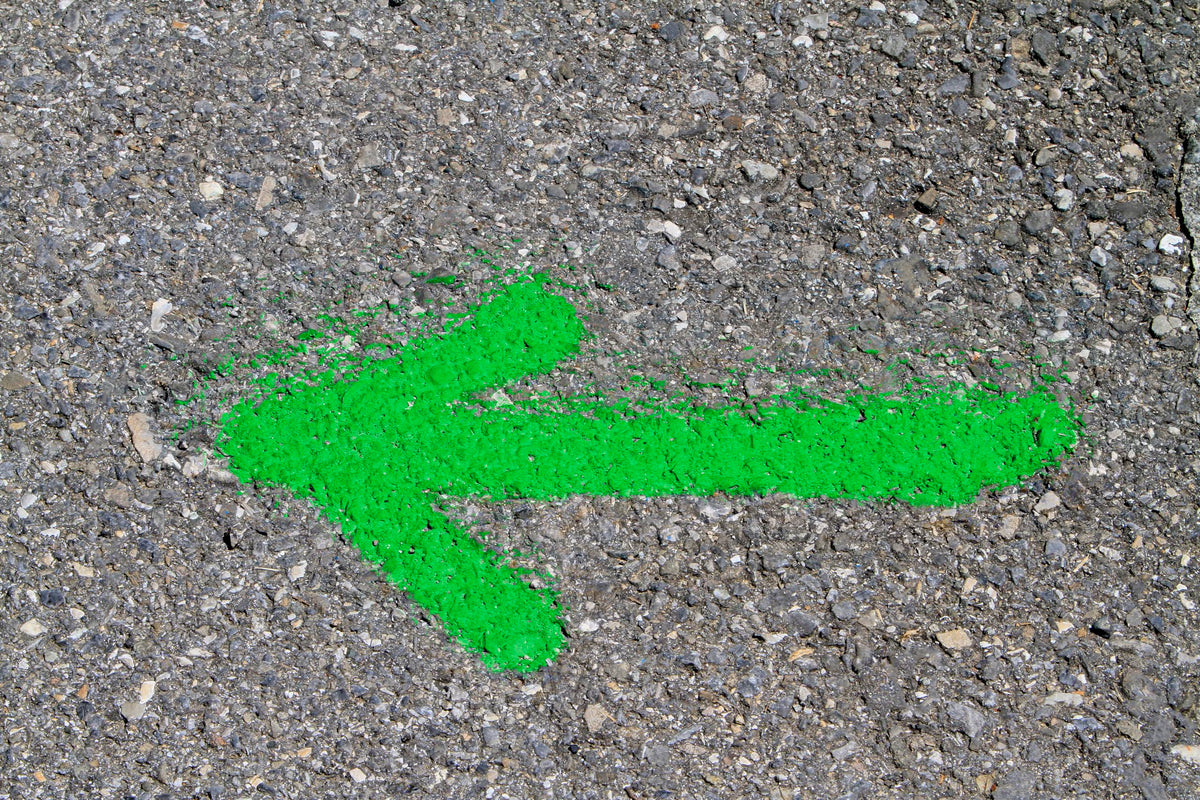 Rust-Oleum fluorescent green exterior marking paint on grass and gravel