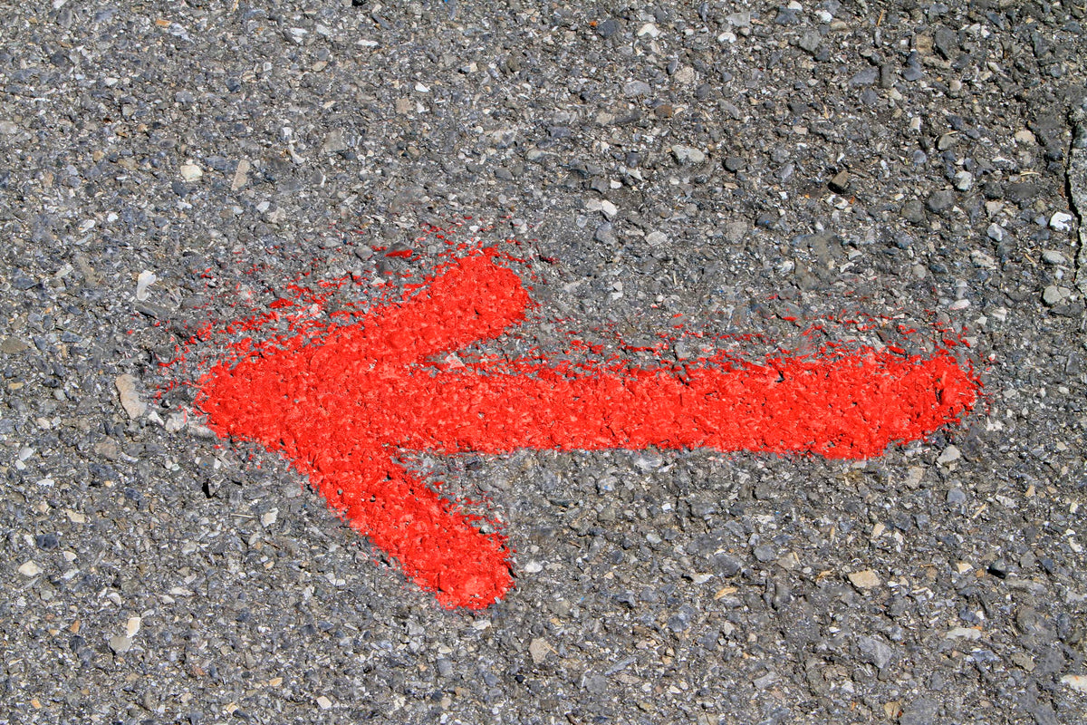 Fluorescent red-orange marking spray marking outdoor field and lot lines.