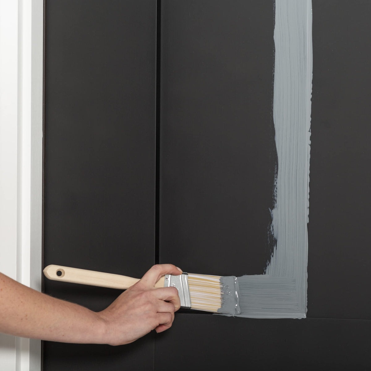 Rust-Oleum brush-on application on a door edge demonstrates easy, low-odor use