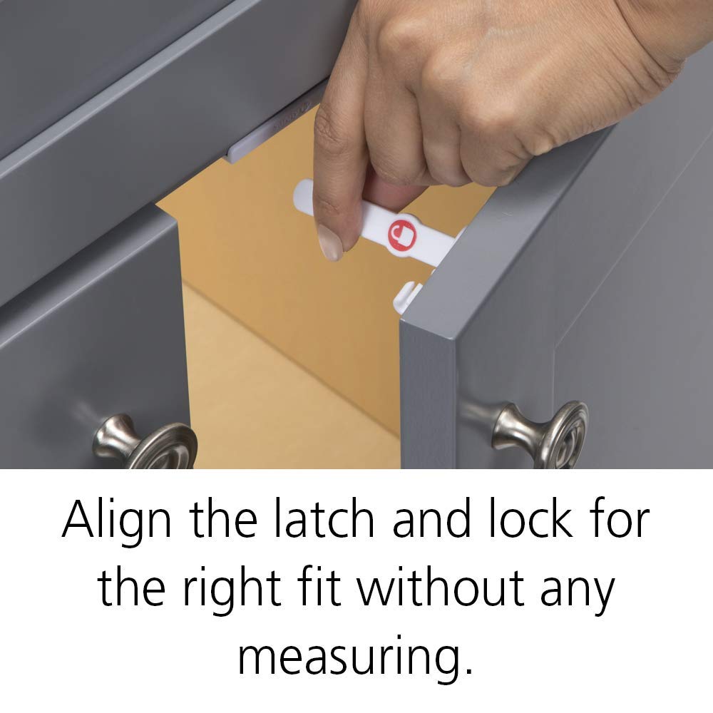 Safety 1st installation template on cabinet surface aids precise latch alignment.