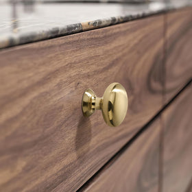 SAILING edge-shot knob mounted on cabinet door.