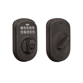 Schlage BE365 Plymouth keypad deadbolt on front door with illuminated keypad for night entry.