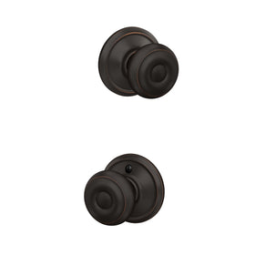 Schlage F10 GEO 716 front view in aged bronze showcases classic hallway style.