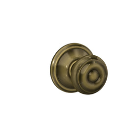 Schlage F10 V GEO 609 Georgian door knob on hall or closet door in antique brass.