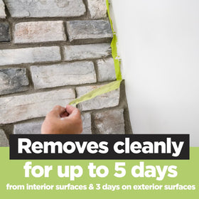 Scotch tape on brick texture protects edges during painting.
