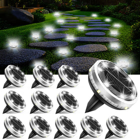 SenLuKit upgraded flat disc solar ground light illuminating a stone path at night