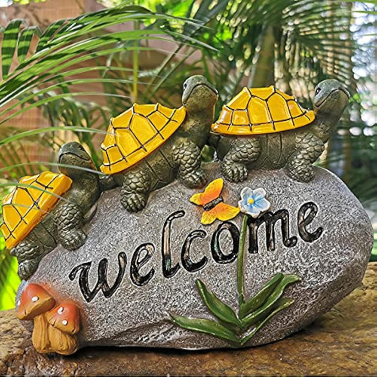 Shumi solar garden statue turtle glowing on rock to welcome guests at night.