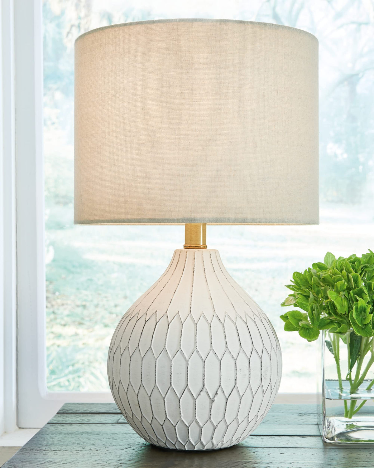Signature Wardmont table lamp shade highlights a soft, diffused glow for cozy spaces.