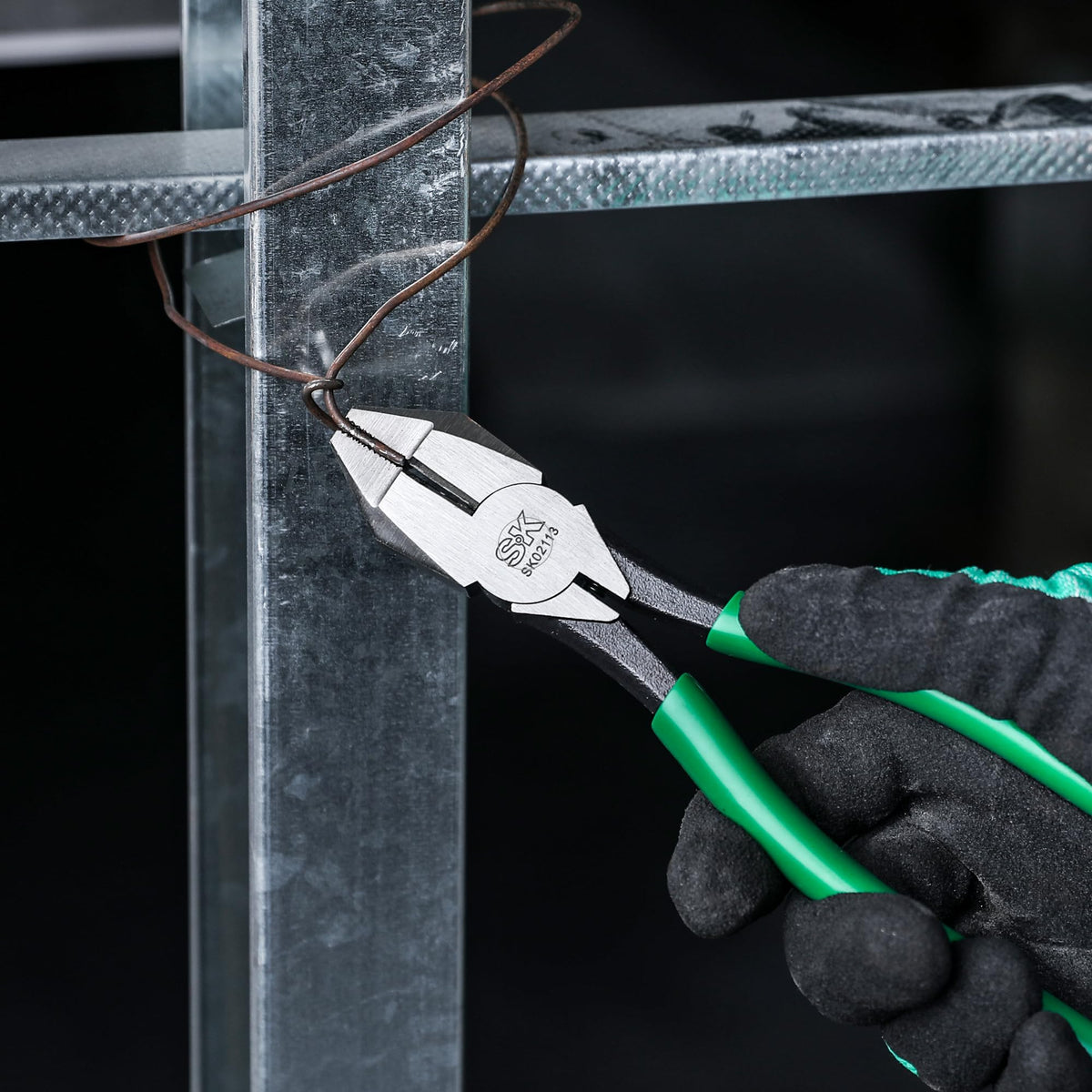 SK 9-inch ironworker's pliers in use with spring-loaded action.