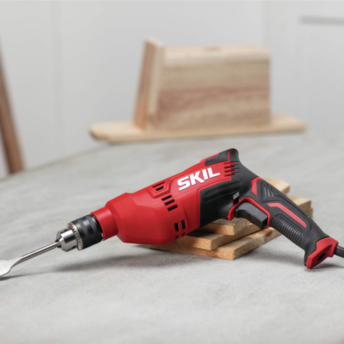 SKIL DL181901 drill shown with side-assist handle for safer, precise drilling