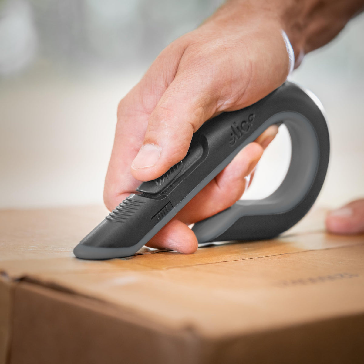 Slice box cutter cutting cardboard demonstrates efficient packaging opening