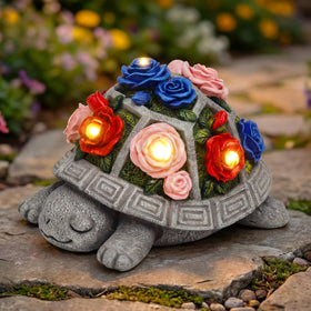Snclriao solar garden turtle statue with multicolor roses glows softly at night.